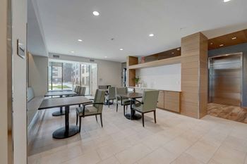 a dining room with tables and chairs and a counter